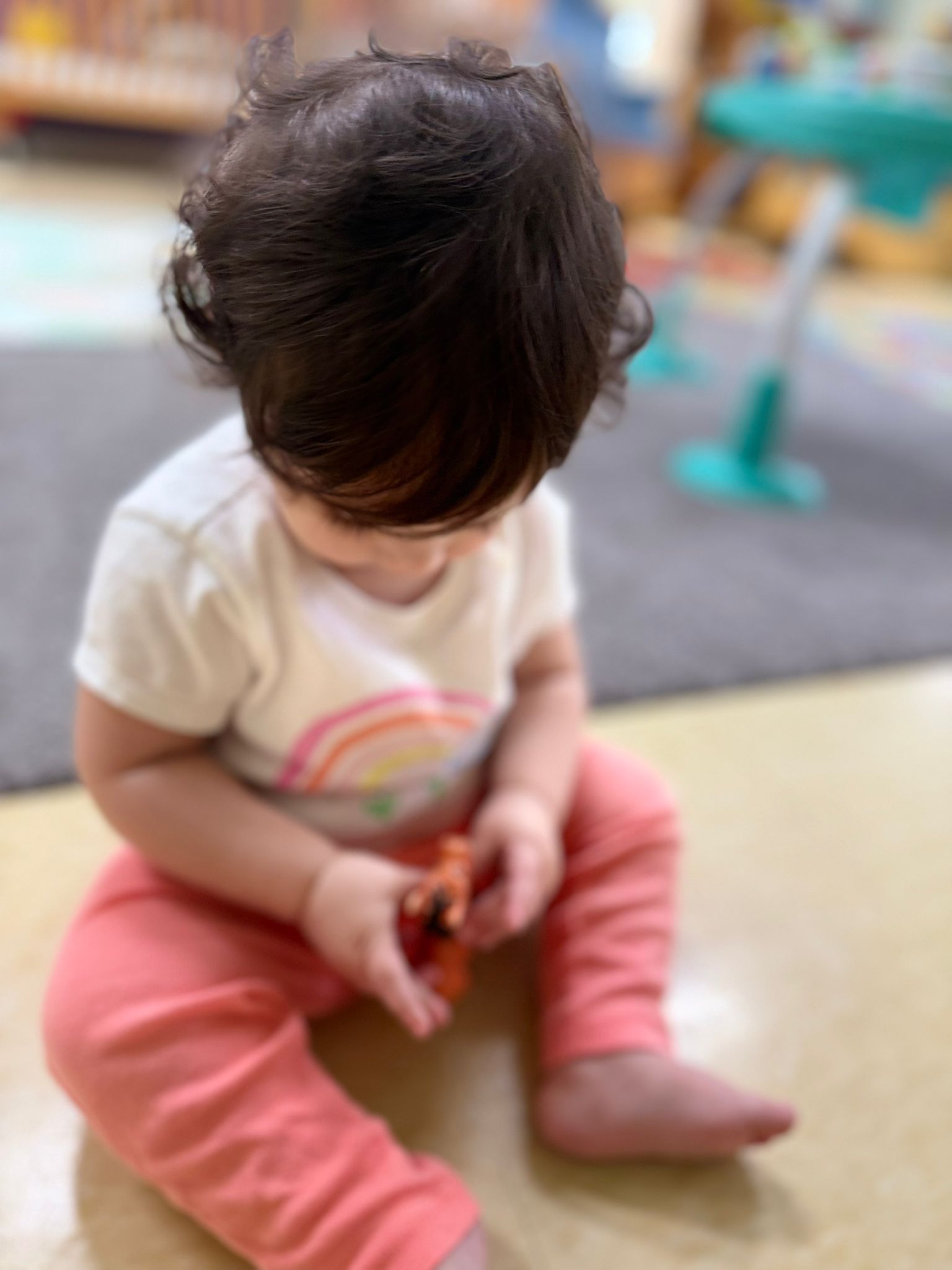 A young toddler at work in the PRE CASA classroom