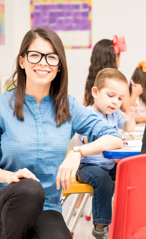 A teacher working alongside students