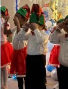 Children performing in elf hats