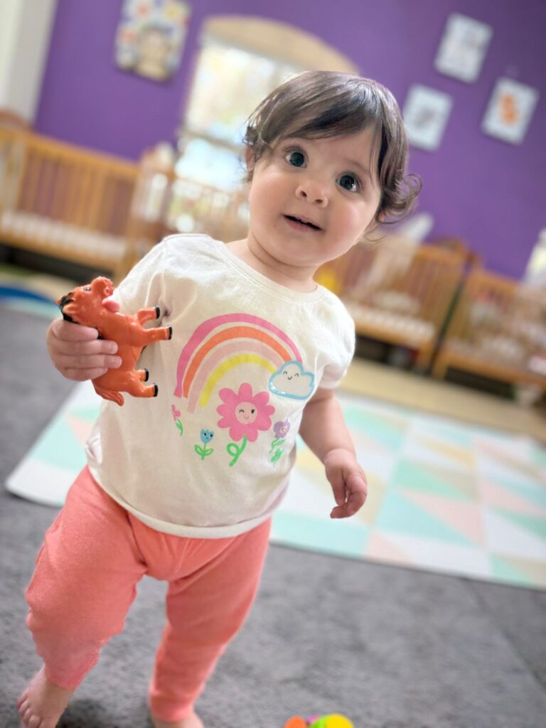 An infant exploring the Creative Minds nursery classroom